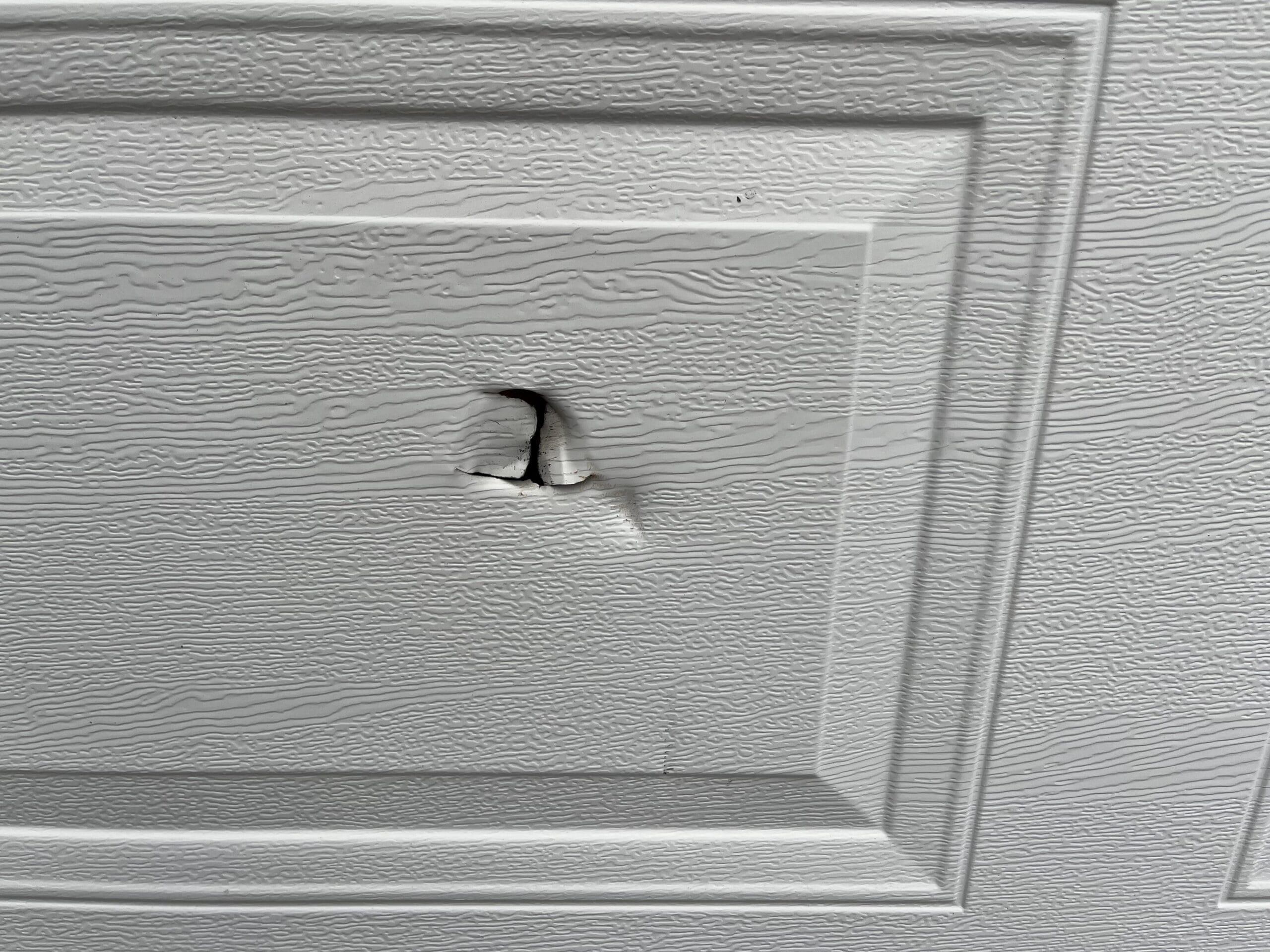 How to Fix Hole in Garage Door